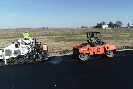Paver and roller placing the BioMAG asphalt mixture during the Boone demonstration.