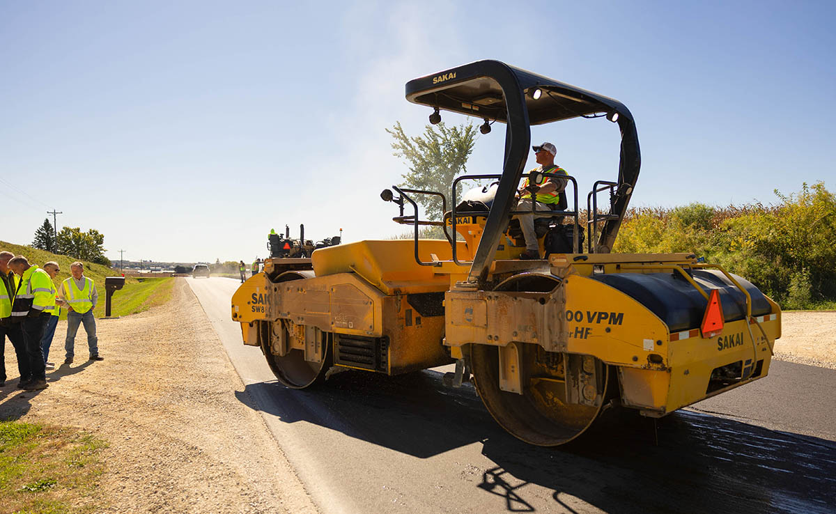 Crew members place soy-modified recycled asphalt during the Northeast Iowa construction program.