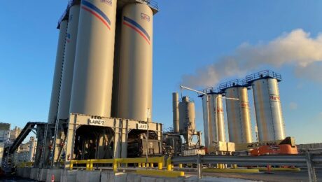 City Asphalt drum plant silos and production equipment under a blue sky in Staten Island.