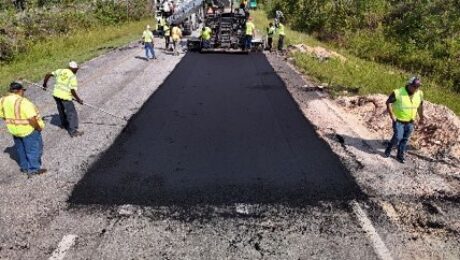 Paving crew placing the dark 50 percent RAP surface layer on NCAT Test Track Section S1.